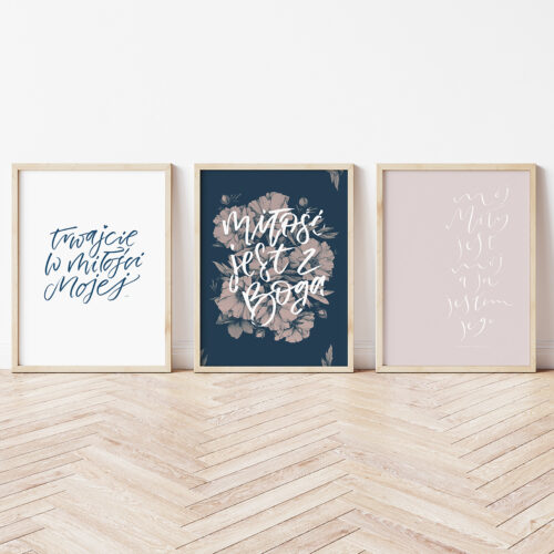 Three vertical wooden frame poster on wooden floor with white wa