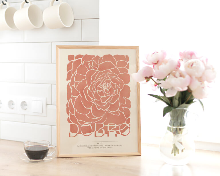 Vertical frame mockup on a wooden table in the kitchen. Glass vase with a bouquet of pink peonies and a cup of black coffee. Scandinavian style interior.